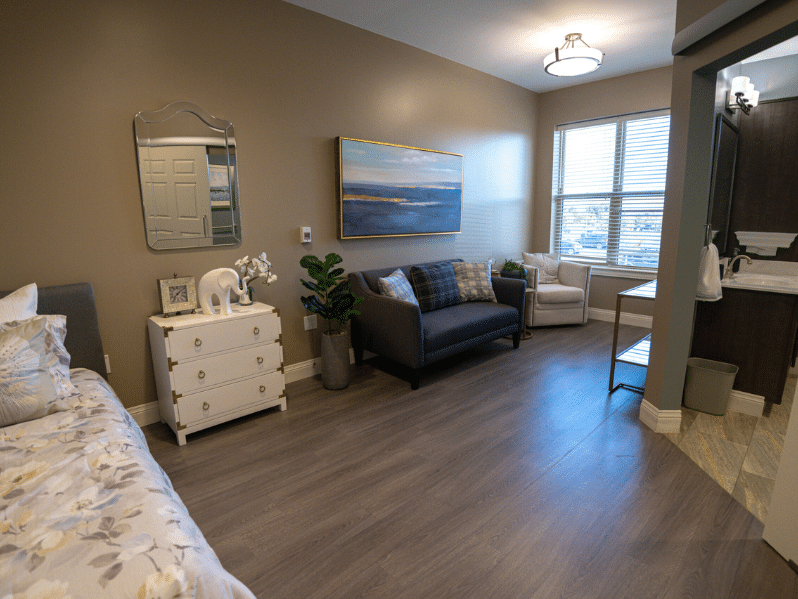 Interior of Memory Support room showing the bed, couch, and bathroom entryway