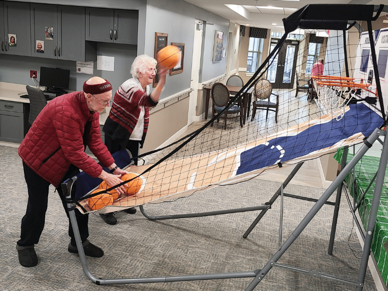 Two residents shoot basketballs
