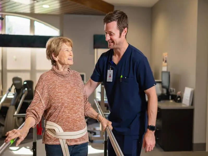 Nurse helping with resident with physical therapy