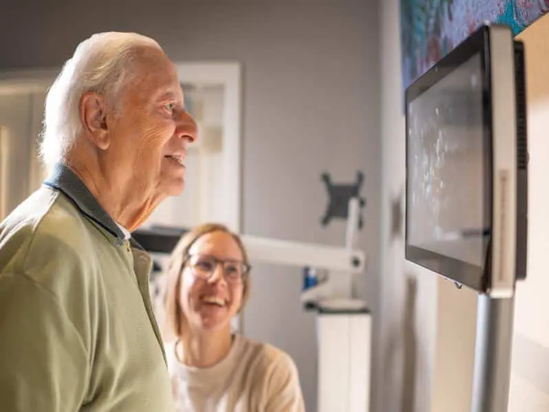 Resident and nurse looking at metrics on health tool