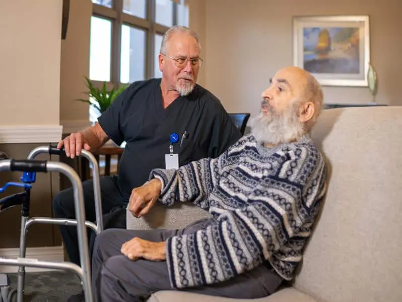 Nurse sitting with resident