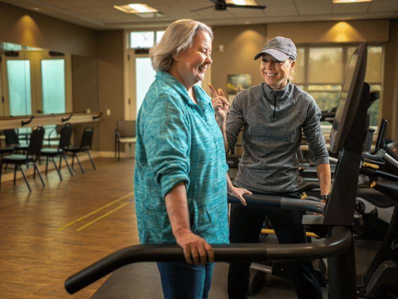 Trainer encouraging woman working out