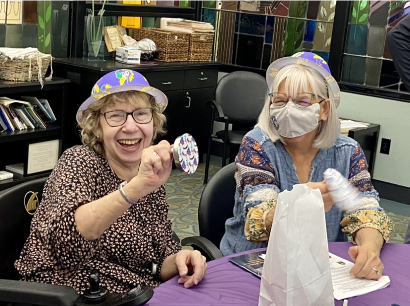 two elderly woman smiling and playing