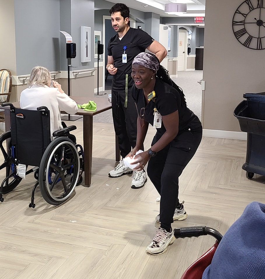 Lynette, nurse in Memory Support playing a game with the residents.