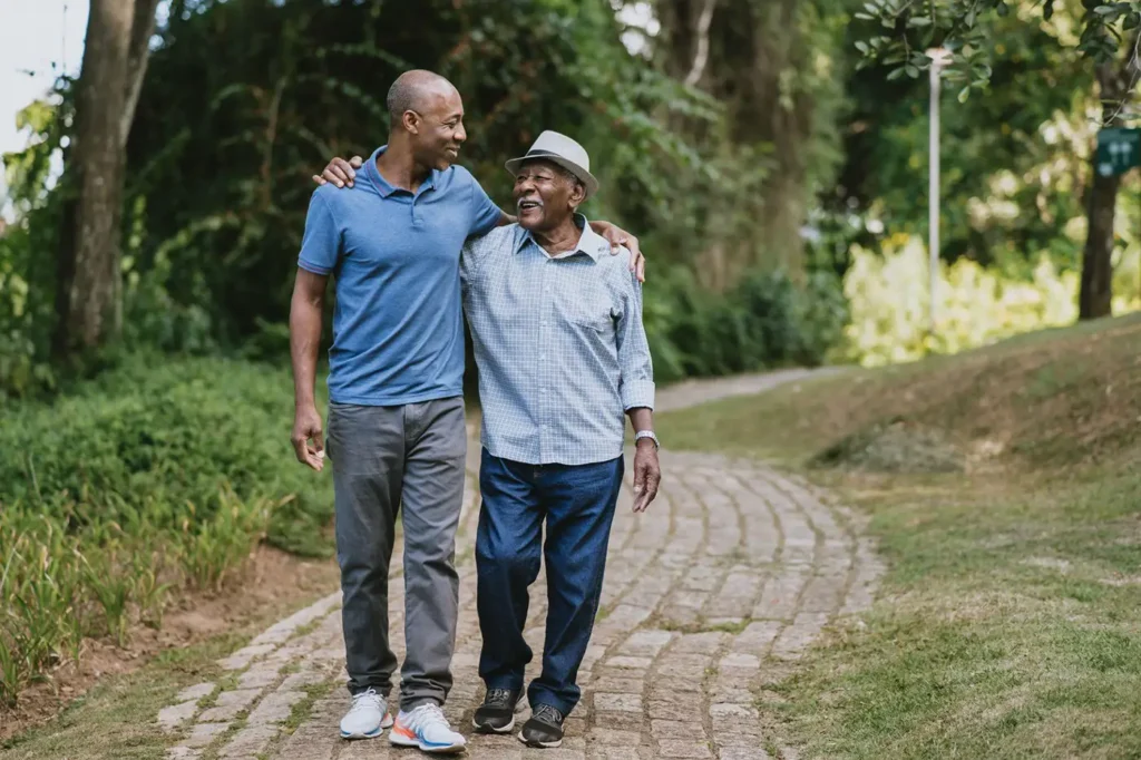 senior man walking with his adult son