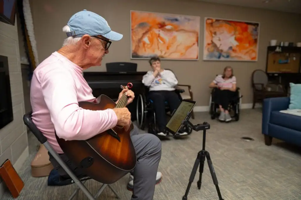 Image of a senior resident class in a music sensory therapy class for residents showing the memory care difference at Village Shalom, a dementia care community in Overland Park, KS.